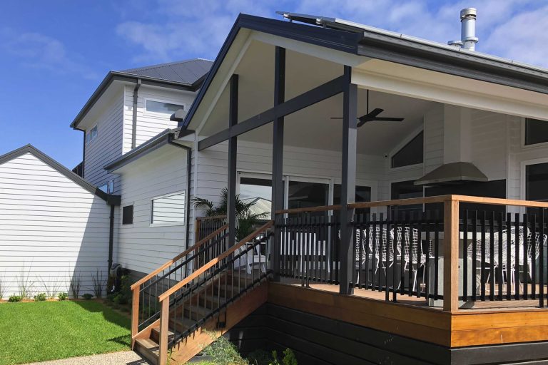 bespoke entry steps leading to outdoor seating, surrounding an external kitchen