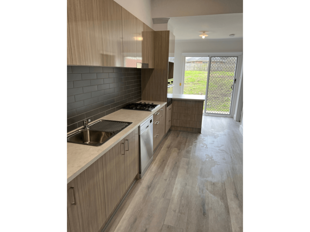 Kitchen renovation with wooden floorboards and matching layout on cupboards