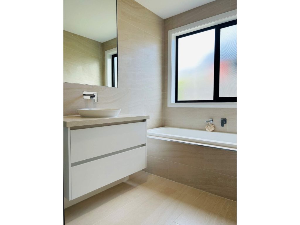 Modern bathroom renovation with bath and handle free draws with minimalist basin and tap design