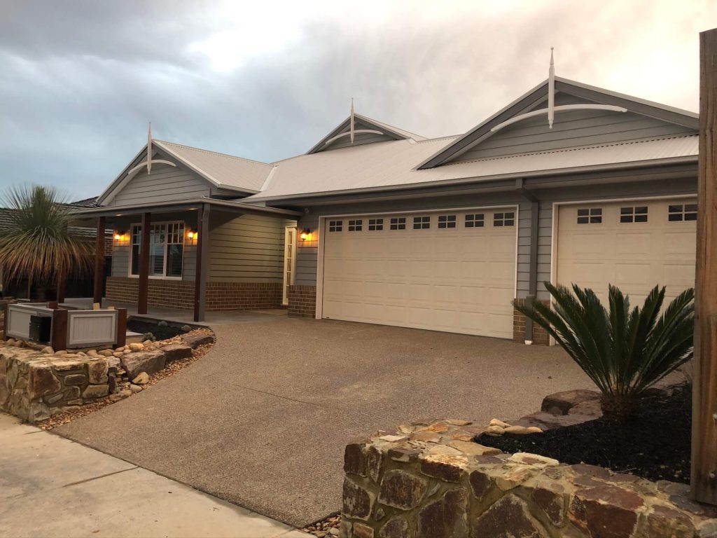 Officer home build front of house entrance with stone surrounding raised garden beds