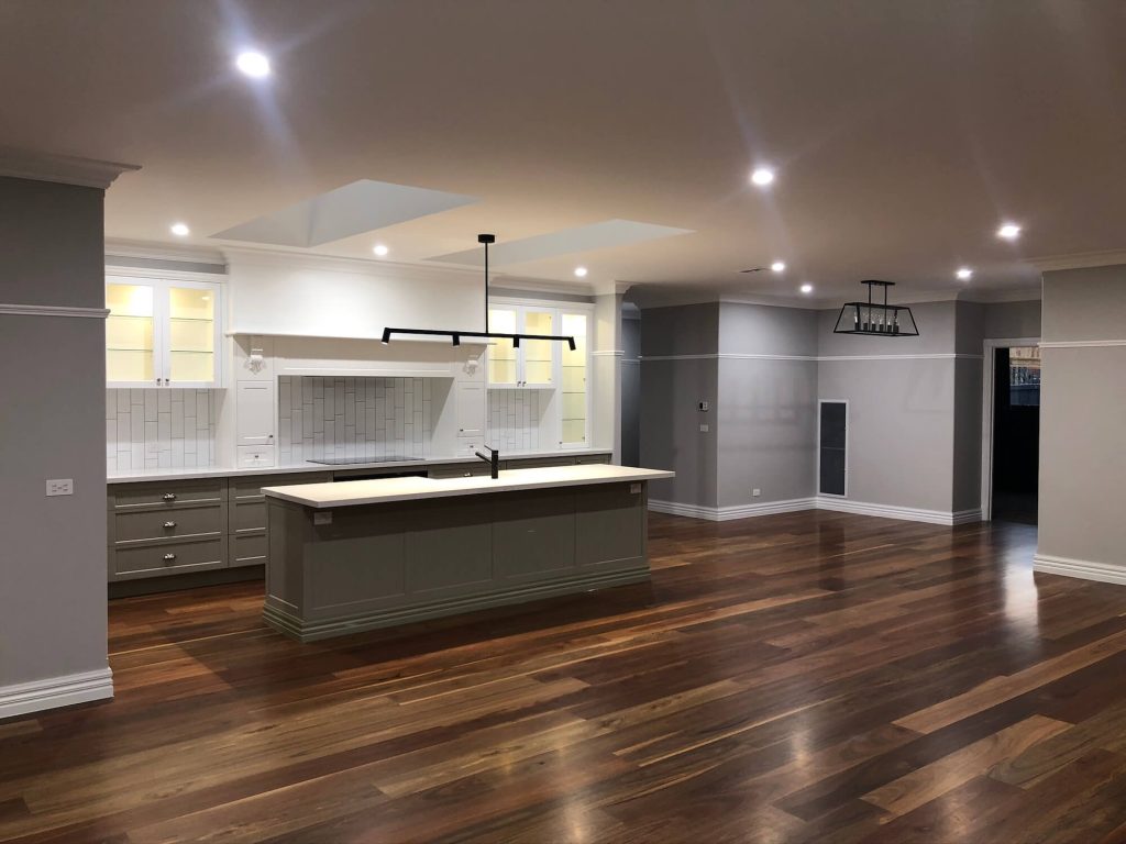 Open kitchen area with wooden floors Officer new home building Victoria Silverleaf Homes with downlights