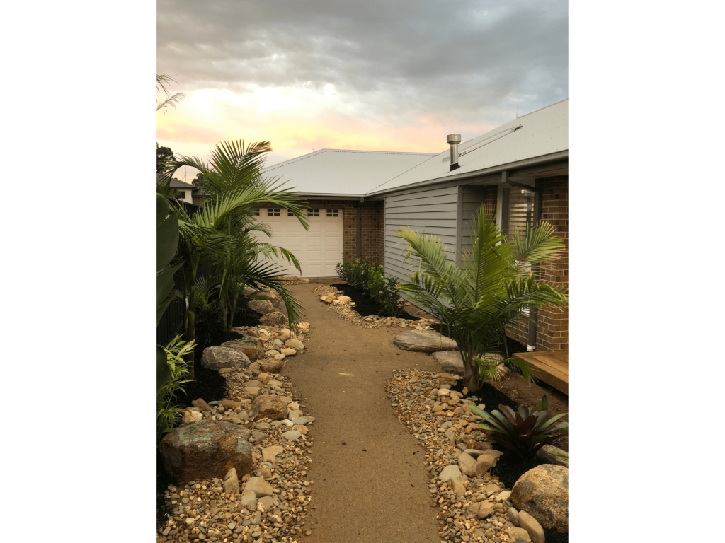 Palm trees with pebbles and rocks decorated for homes entrance landscaping in Officer