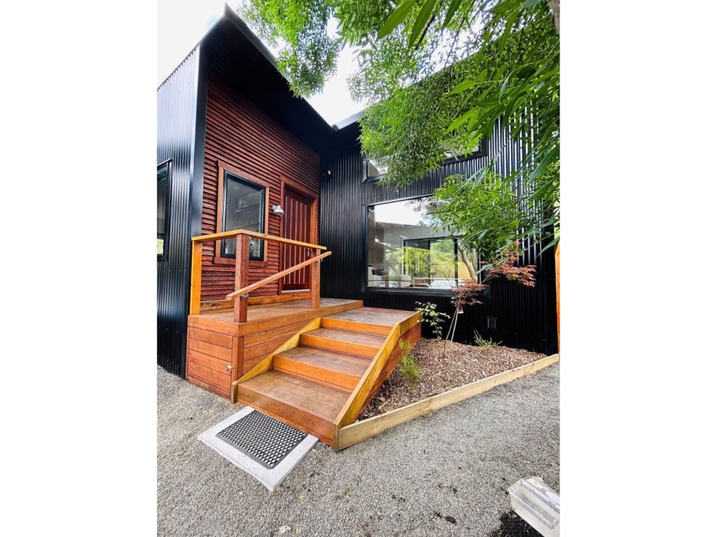 Phillip Island home build with wooden stair case and wide open windows in steel frame